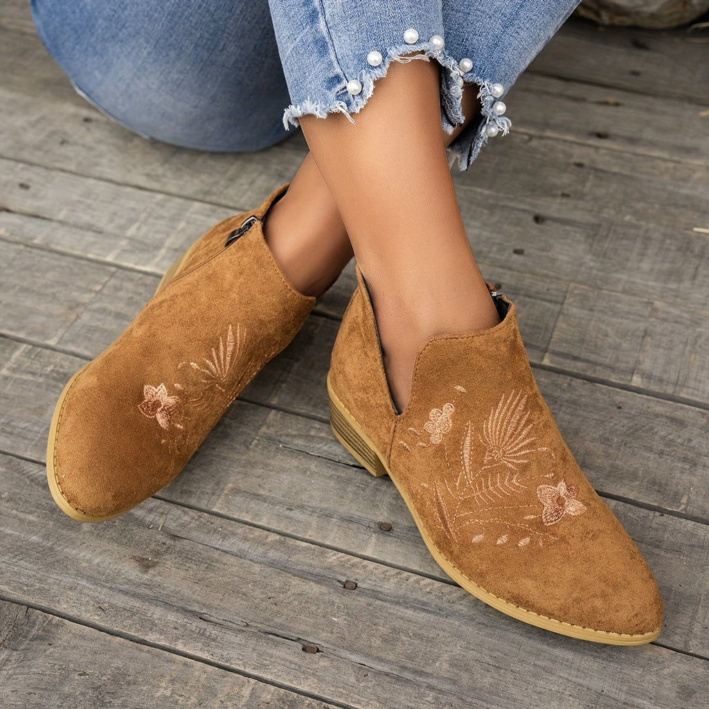 Botines marrón claro para mujer con bordado, sentada con los pies cruzados